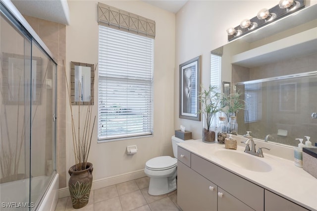 full bathroom with shower / bath combination with glass door, vanity, toilet, and tile patterned flooring