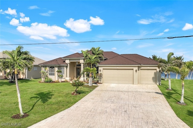 view of front of house featuring a garage and a front lawn