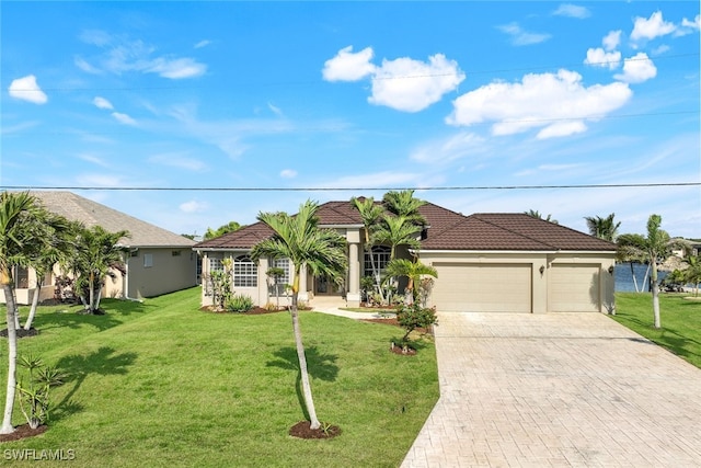 view of front of home with a garage and a front lawn