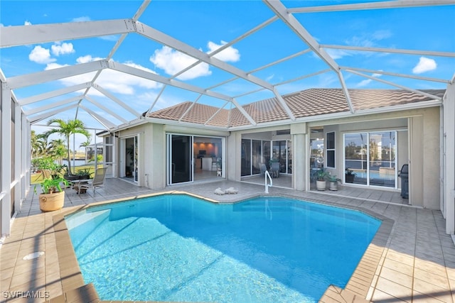 view of pool featuring a patio area and glass enclosure