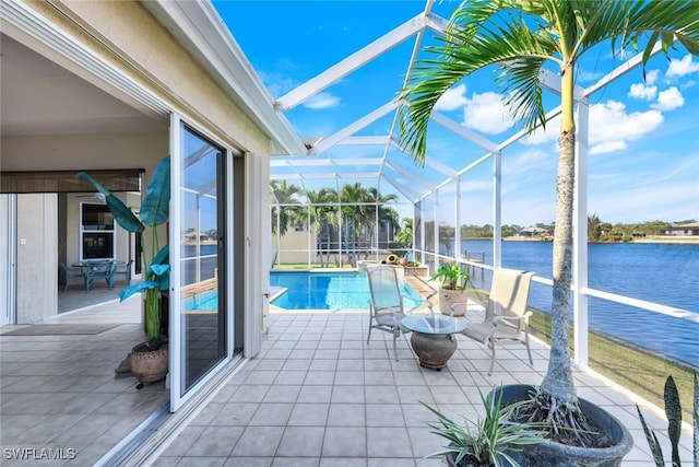 view of swimming pool featuring a patio area, a water view, and glass enclosure