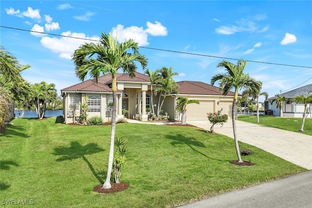 mediterranean / spanish-style house featuring a garage and a front lawn