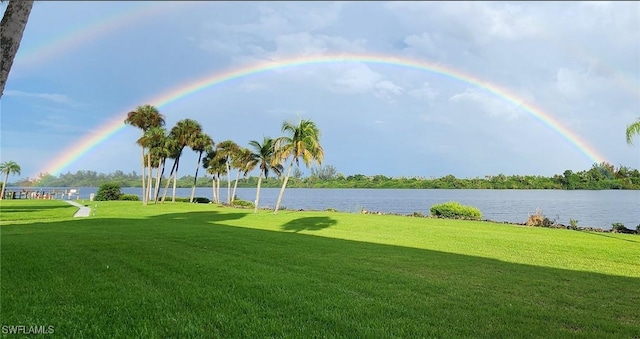 surrounding community with a water view and a yard