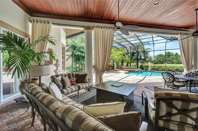 sunroom / solarium with ceiling fan, a healthy amount of sunlight, and a pool