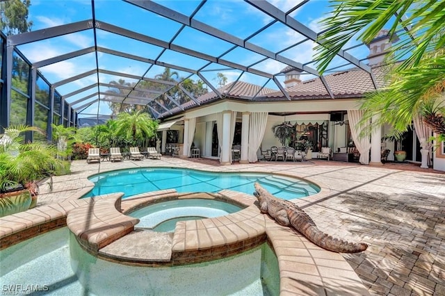 view of pool featuring an in ground hot tub, a patio area, and a lanai