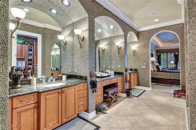 bathroom with vanity, vaulted ceiling, and ornamental molding