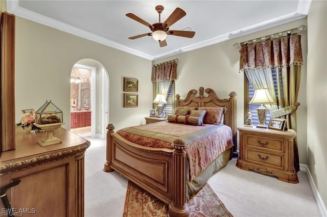 carpeted bedroom with ensuite bathroom, ceiling fan, and crown molding