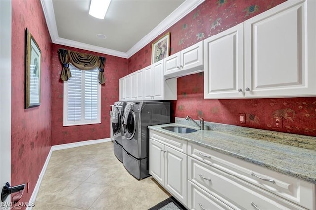 washroom featuring cabinets, sink, crown molding, washer and dryer, and light tile patterned flooring