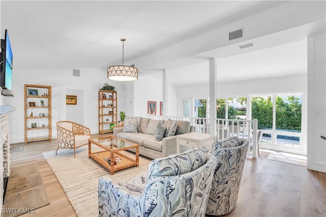 living room featuring light hardwood / wood-style floors and lofted ceiling