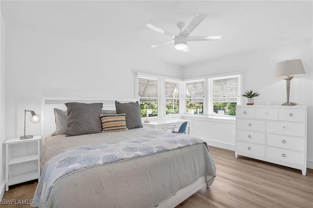 bedroom with ceiling fan and hardwood / wood-style flooring