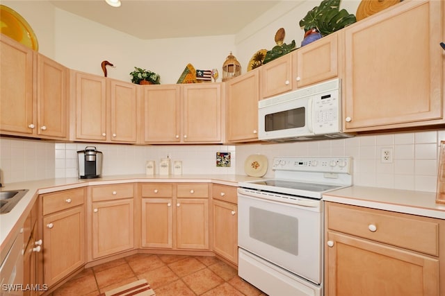 kitchen featuring decorative backsplash, light brown cabinets, and white appliances