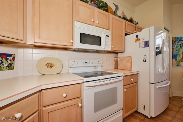 kitchen featuring decorative backsplash, light brown cabinetry, light tile patterned floors, and white appliances