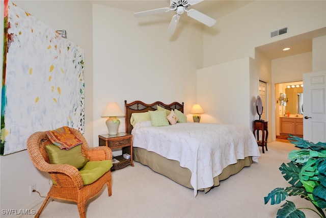 bedroom with ceiling fan, carpet floors, and connected bathroom