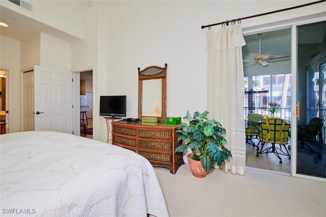 bedroom featuring carpet and a high ceiling