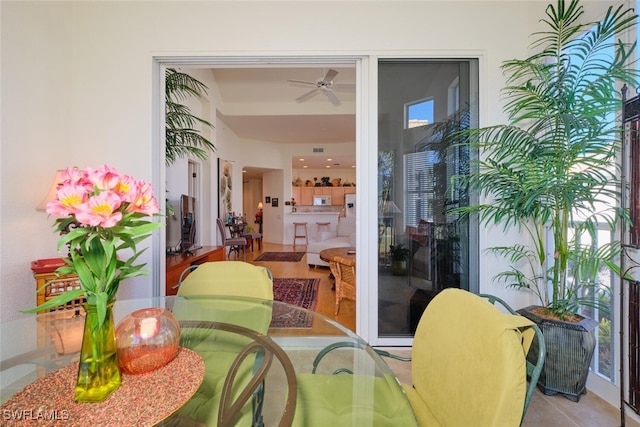 dining space with light tile patterned floors and ceiling fan