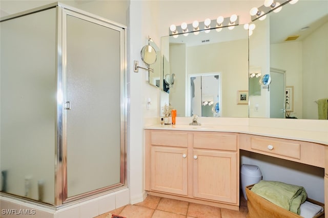 bathroom featuring tile patterned floors, vanity, and a shower with door