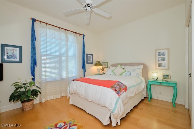 bedroom with wood-type flooring and ceiling fan