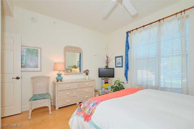 bedroom with ceiling fan and light hardwood / wood-style floors