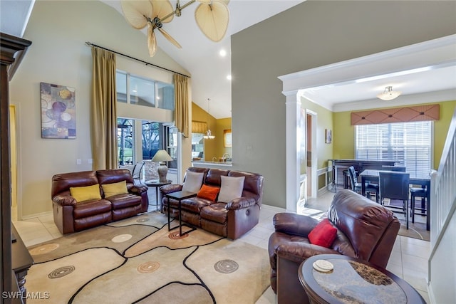 living room with vaulted ceiling, ornate columns, and light tile patterned flooring