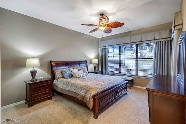 bedroom featuring light carpet and ceiling fan