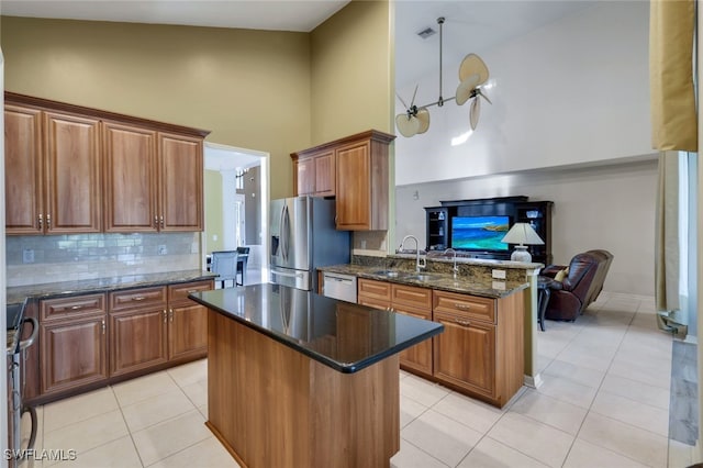 kitchen with high vaulted ceiling, stainless steel fridge, white dishwasher, a kitchen island, and dark stone counters