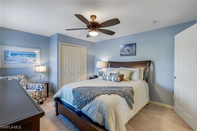 bedroom featuring light carpet, a closet, and ceiling fan