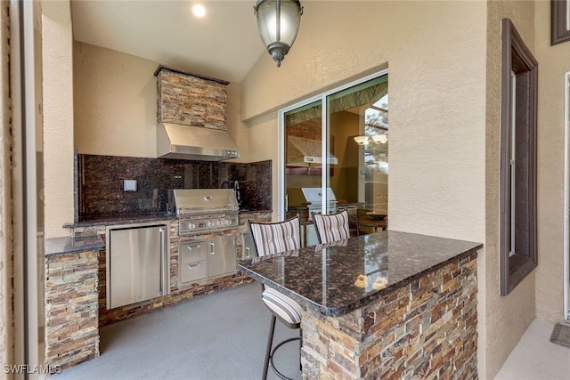 view of patio / terrace featuring area for grilling, exterior bar, and exterior kitchen