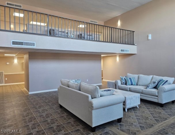 living room featuring a towering ceiling