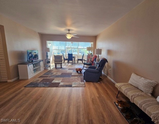 living room with ceiling fan and wood-type flooring