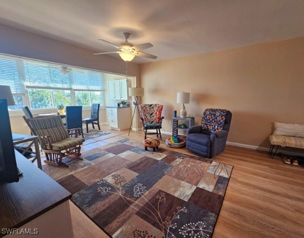 living room featuring hardwood / wood-style flooring and ceiling fan