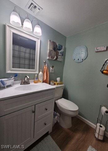 bathroom featuring hardwood / wood-style floors, vanity, and toilet