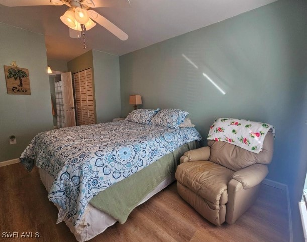 bedroom featuring ceiling fan, a closet, and hardwood / wood-style flooring