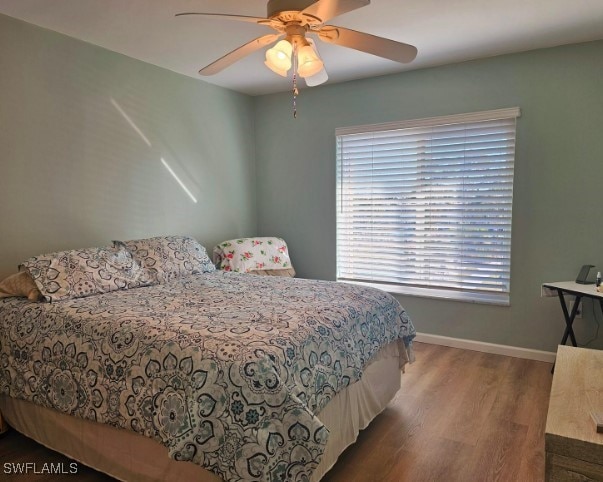 bedroom featuring hardwood / wood-style flooring and ceiling fan