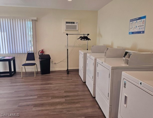 laundry area with dark hardwood / wood-style flooring, separate washer and dryer, and a wall mounted AC