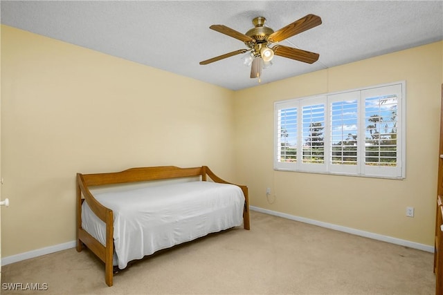 bedroom featuring ceiling fan and light carpet