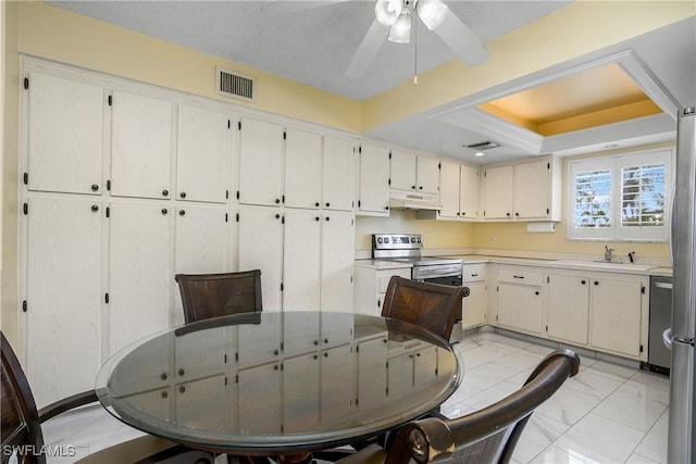 dining area featuring ceiling fan and sink