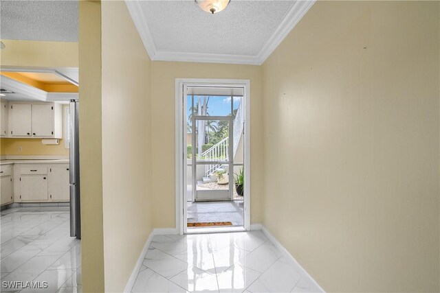 doorway featuring crown molding and a textured ceiling