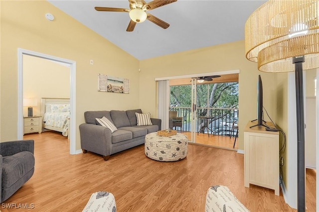 living area with ceiling fan, vaulted ceiling, baseboards, and wood finished floors