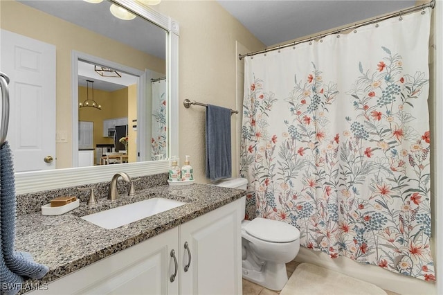 bathroom with vanity, toilet, and tile patterned floors