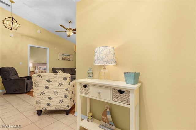 living area with lofted ceiling, tile patterned flooring, visible vents, and ceiling fan with notable chandelier