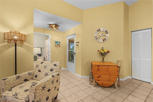 corridor featuring light tile patterned floors and baseboards