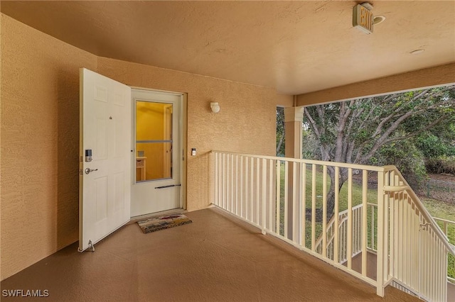 exterior space with a balcony and stucco siding