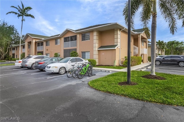 view of property featuring uncovered parking