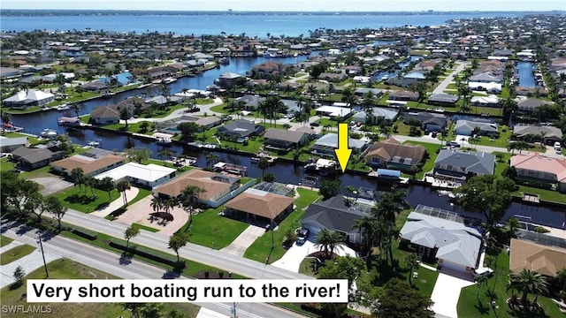 drone / aerial view with a water view and a residential view