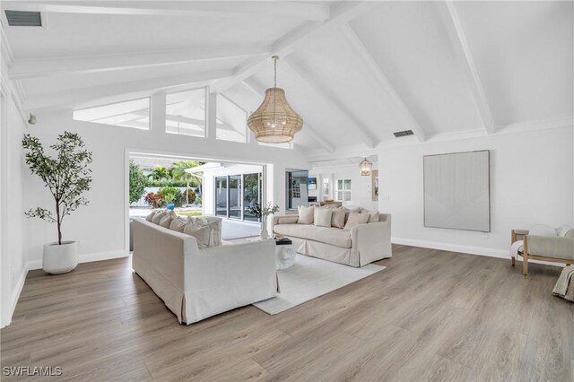 living room featuring beamed ceiling, high vaulted ceiling, and light wood-type flooring