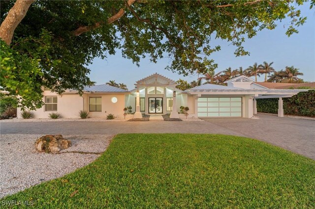 view of front of home with a garage and a front yard