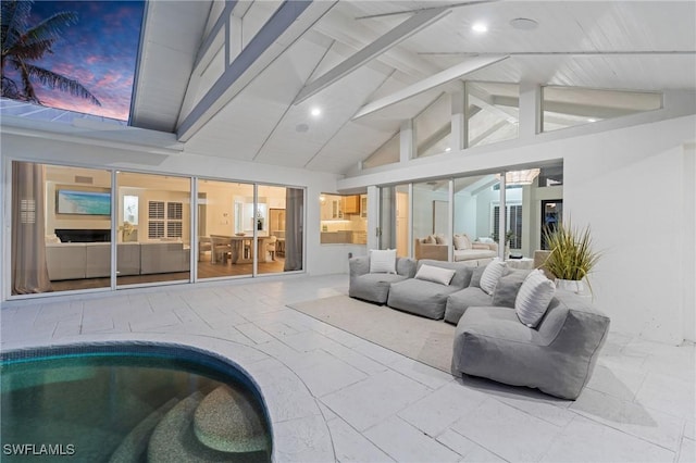 living room with beamed ceiling and high vaulted ceiling