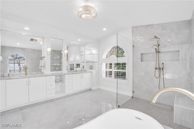 bathroom featuring a healthy amount of sunlight, plus walk in shower, vaulted ceiling, and vanity