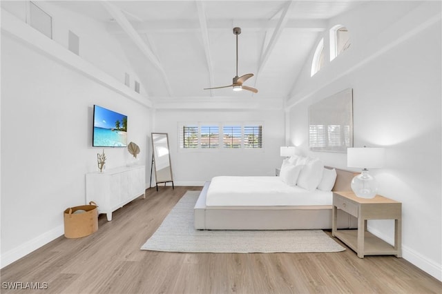 bedroom with beam ceiling, light hardwood / wood-style flooring, high vaulted ceiling, and ceiling fan