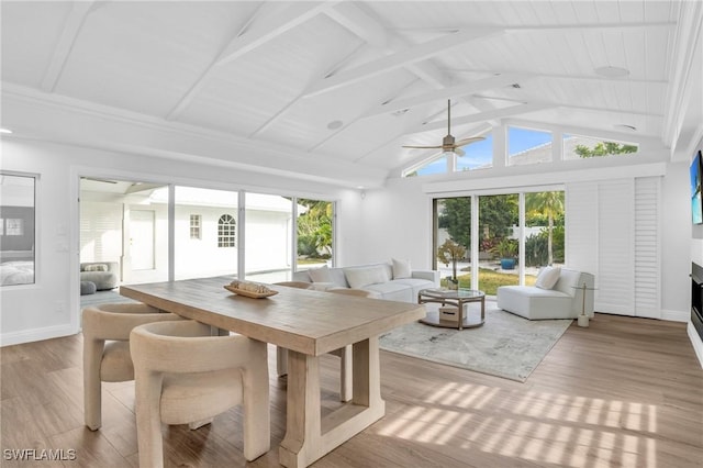 sunroom with a wealth of natural light, lofted ceiling with beams, and ceiling fan